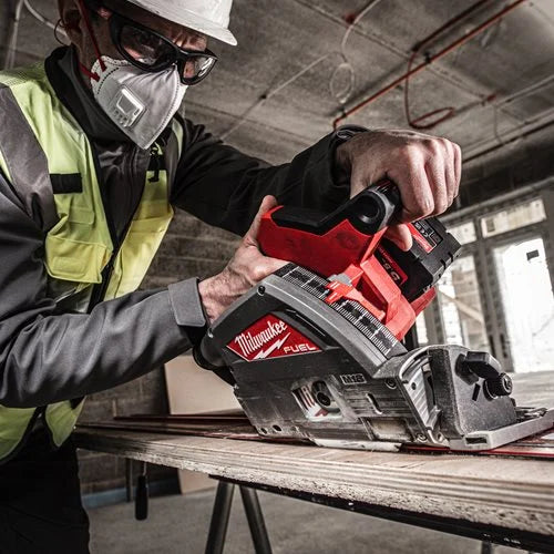 Person using a Milwaukee power tool in a construction setting
