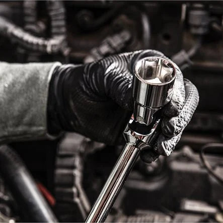 Hand wearing a black glove holding a ratchet wrench 