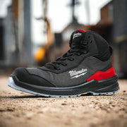 A pair of black Flextred S1PS Safety Boots with red accents and a lace-up closure. The boots have a high upper, featuring a composite toe cap and a textilene upper material for ventilation.