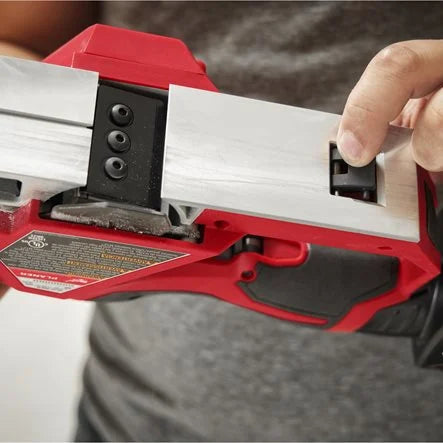 Person using a red and black power tool with a close-up of the blade.