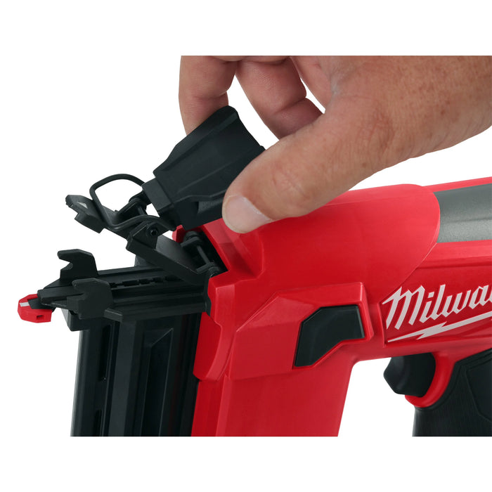 Red Milwaukee nail gun with a hand holding the trigger
