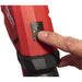 Hand pressing a button on a red Milwaukee tool 