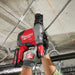 Person using a Milwaukee power tool in an industrial setting