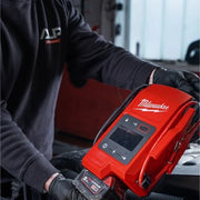 Milwaukee M18 Jump Starter JS2000-0 being used in a workshop with an M18 battery installed