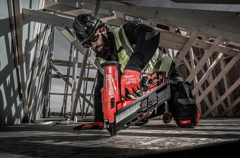 Person using a Milwaukee powert tool in a construction setting
